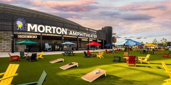 Outdoor seating and games at Morton Amphitheater during sunset.