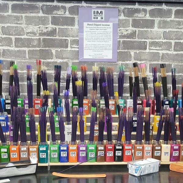 different colored bottled full of incense sticks