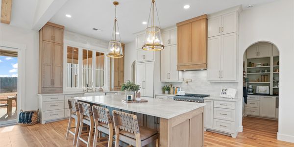 Bright modern kitchen with wooden accents and a large island with seating.