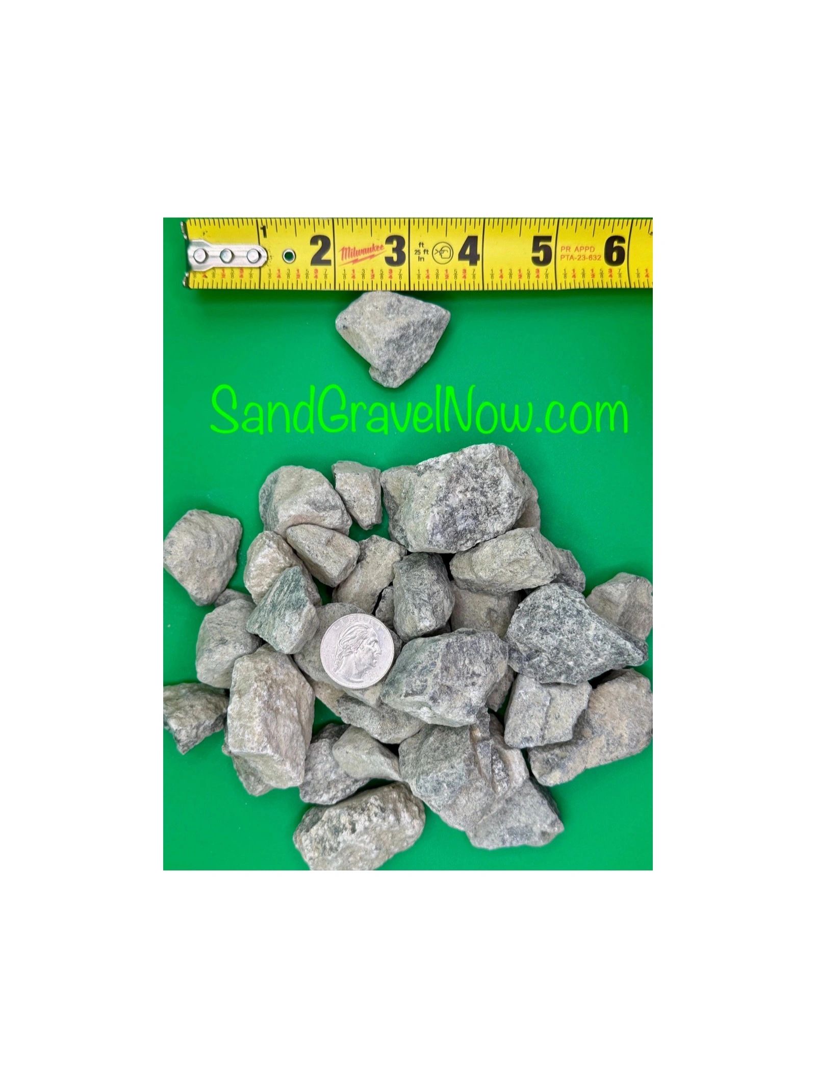 Pile of gray gravel with measuring tape and quarter for scale.