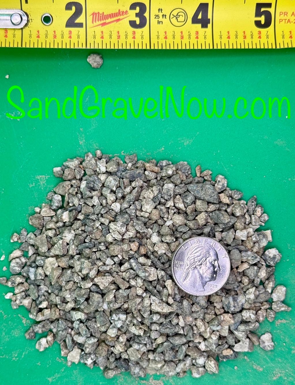Small gravel pieces with a quarter and measuring tape for scale.