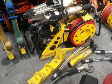Rescue hydraulic tools and equipment on the ground.