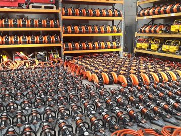 Rows of electric hedge trimmers neatly arranged.