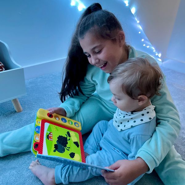 My two children enjoying books together.