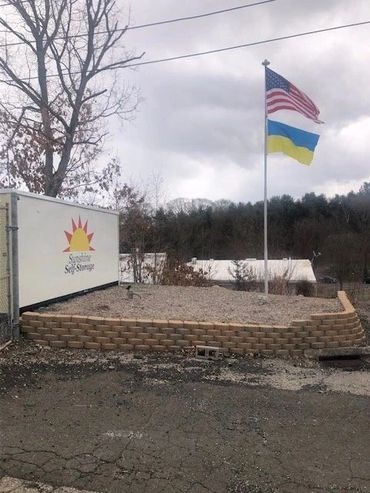 American and Ukraine flag with board sunshine sales storage