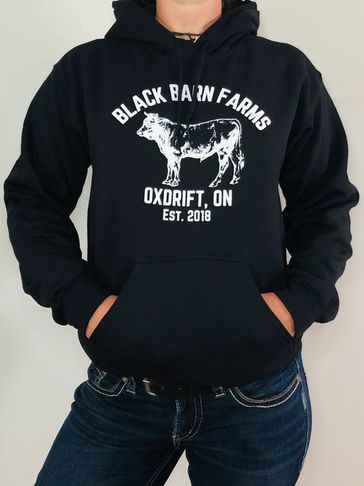 Model wearing Black Barn Farms cow hoodie