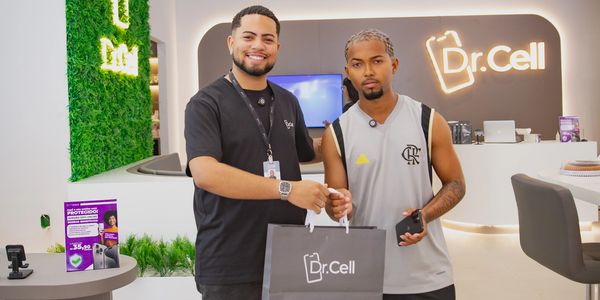 Two men posing with a Dr. Cell branded shopping bag in a modern store.