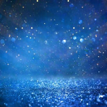 Blue glitter particles sparkling under light.