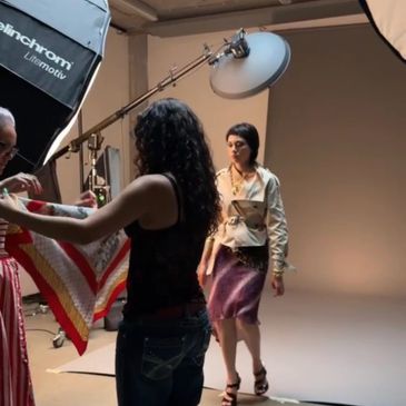 Model walking in a studio photoshoot setup.