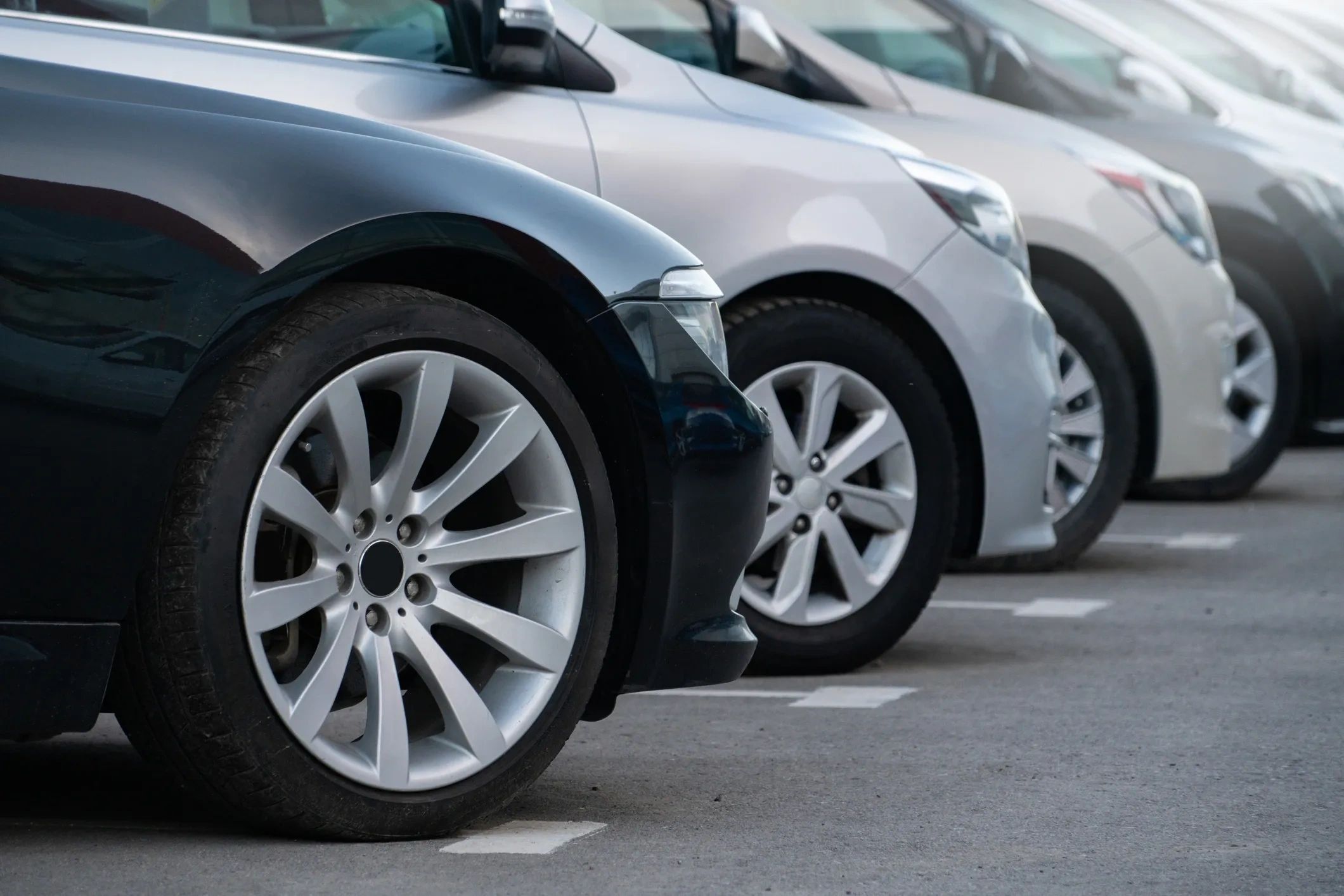 Row of parked cars in a parking lot.