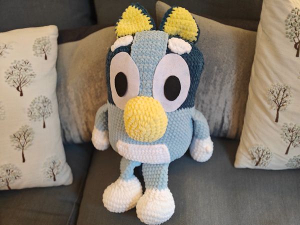 A crocheted bluey plushie