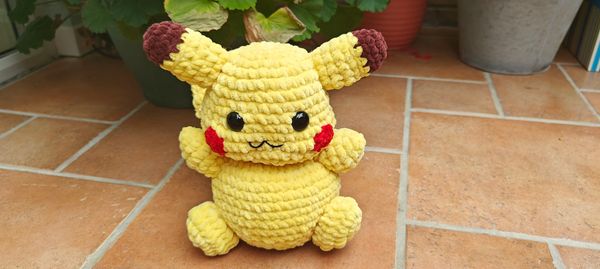 A crocheted plushie of a pikachu