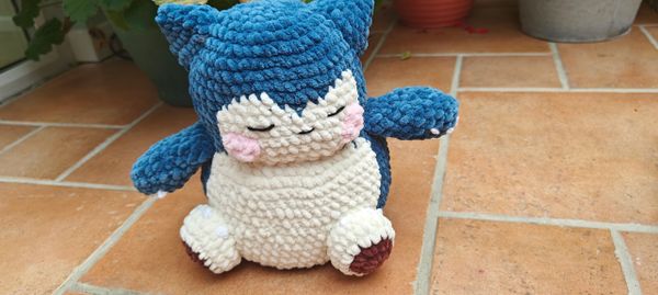 A crocheted plushie of a Snorlax