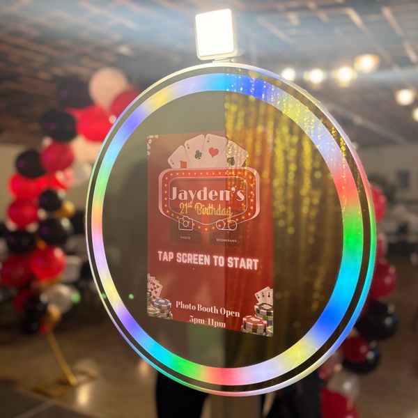 Colorful photo booth ring light at Jayden's 21st birthday party with casino-themed decor.
