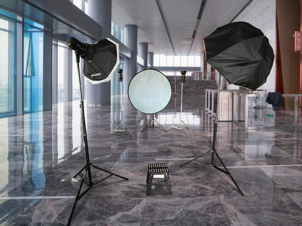 Professional photography lighting equipment set up in a modern studio space.