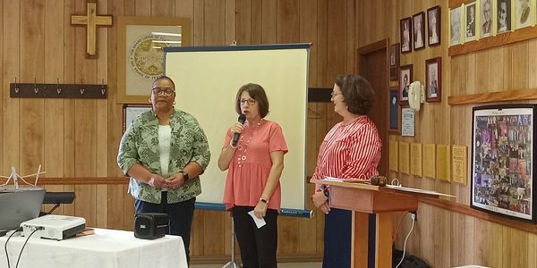 Capitol District Fall Board depicting  Juanice, President Amy McDaniel with Lucy Wiggins from Frankl