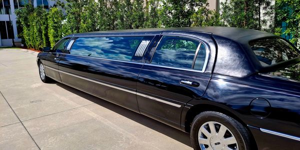 Black stretch limousine parked outdoors.