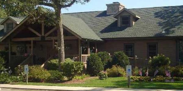 Cozy house with green roof and front yard.