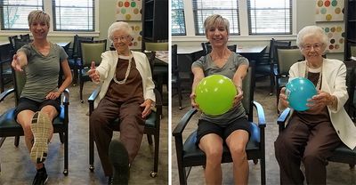 A woman in assisted living follows the instructor in a fitness class