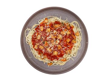 Spaghetti with shrimp and tomato sauce topped with grated cheese on a gray plate.