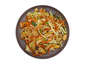 A colorful plate of mixed sautéed vegetables including carrots, mushrooms, and baby corn.