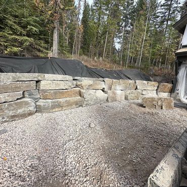 Retaining wall for a luxury residential build. Each stone is placed using an excavator. 