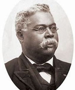 Black and white portrait of an older man with glasses and a mustache.