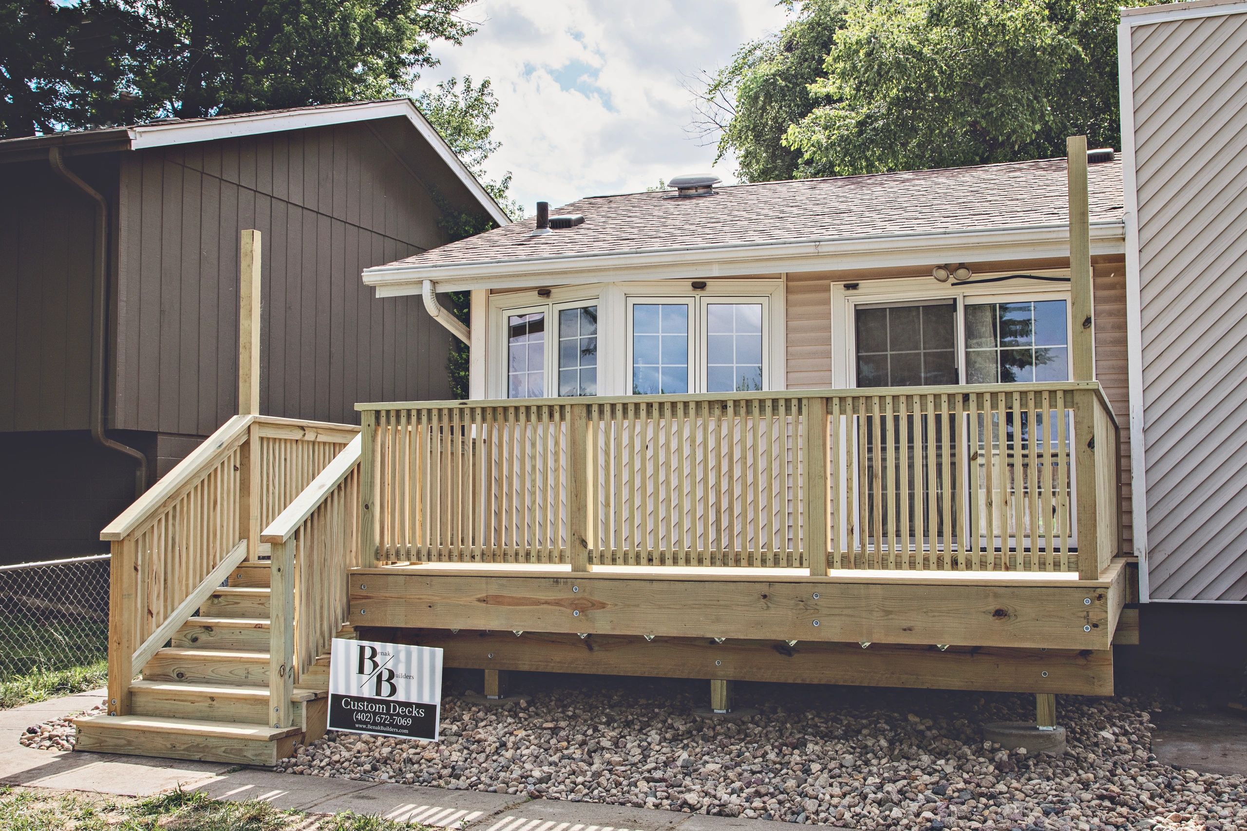 New wooden deck addition to a house.