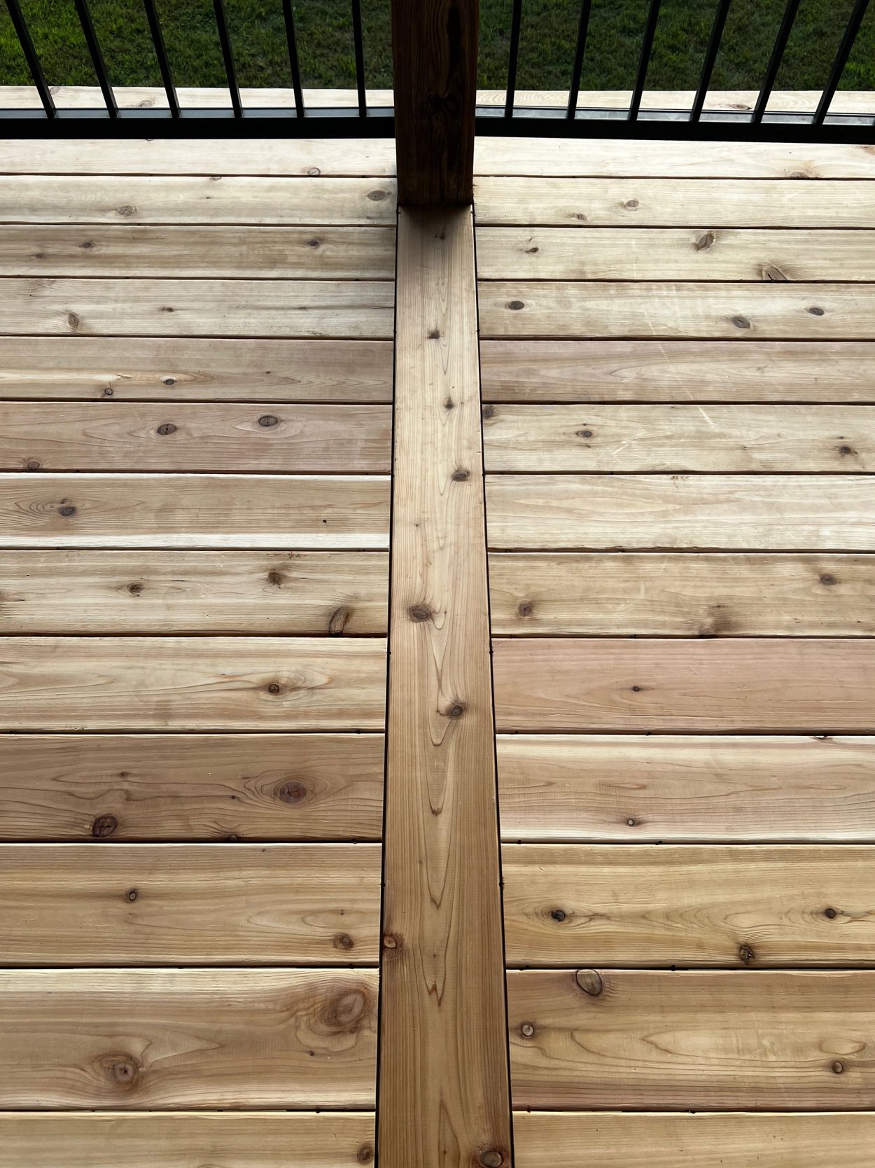 Wooden deck floor with central post.