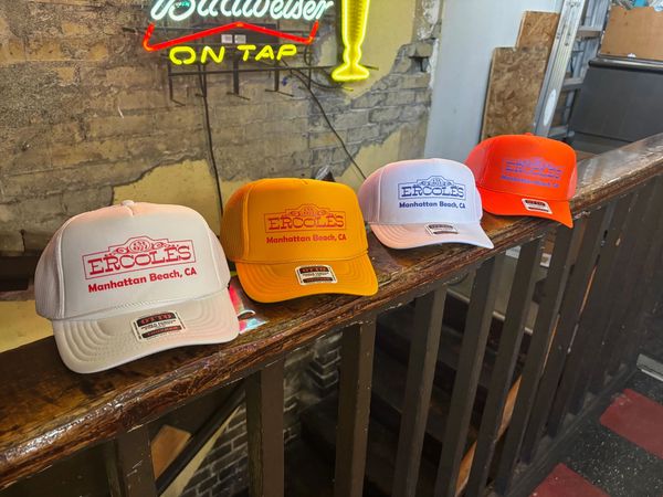 4 Foam trucker hats: white with red outline, yellow with red, white with blue, and orange with blue.
