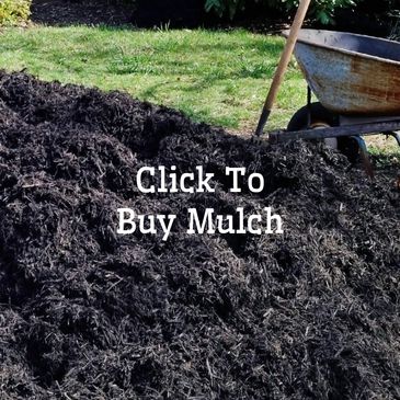 Pile of bulk black mulch delivered in a driveway