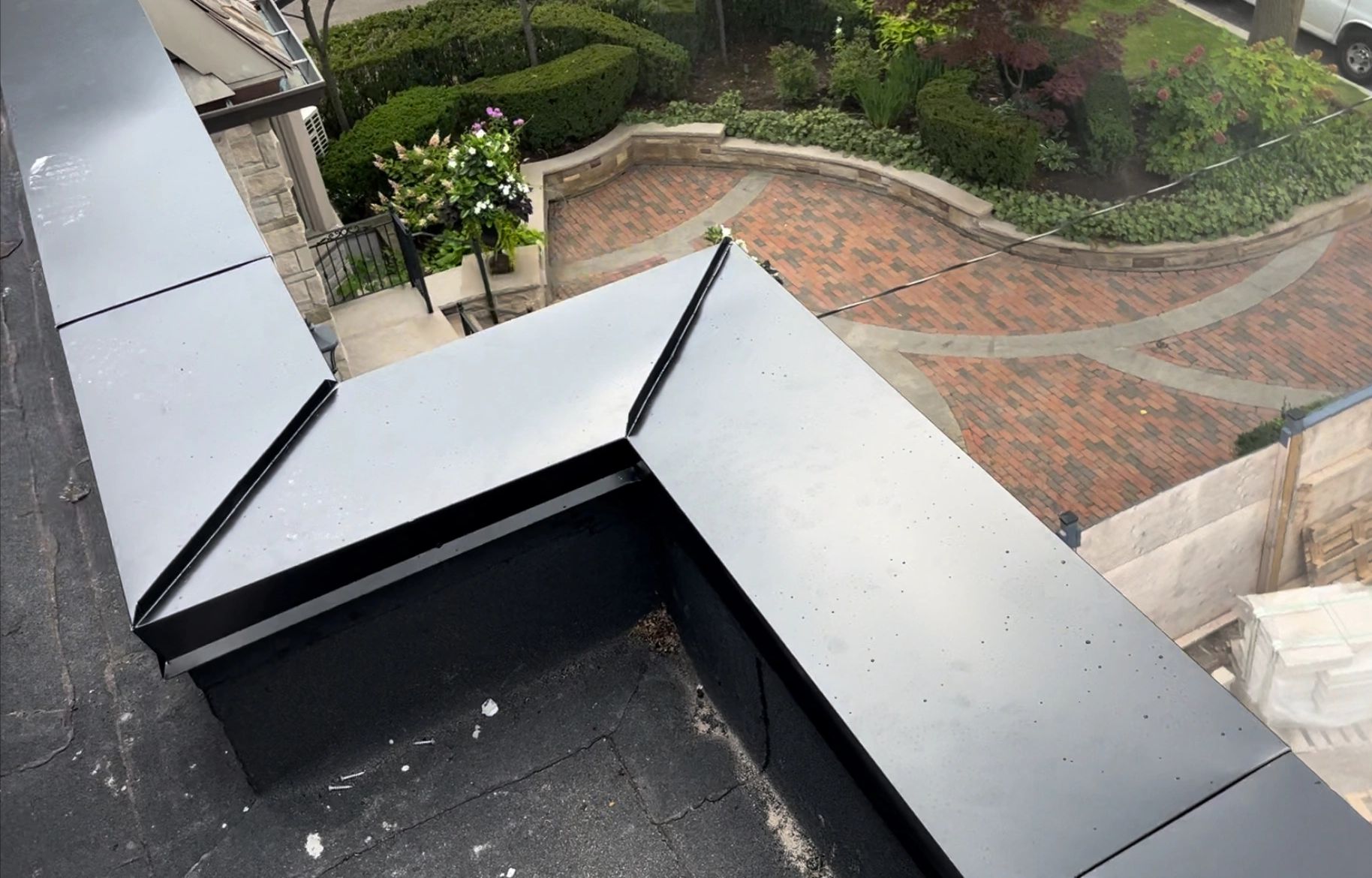 24 Gauge Pre-painted galvanized steel cap on roof parapet.