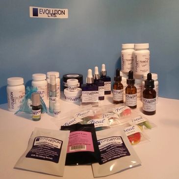 A variety of Evolution Labs CBD products arranged on a white surface with a blue background.