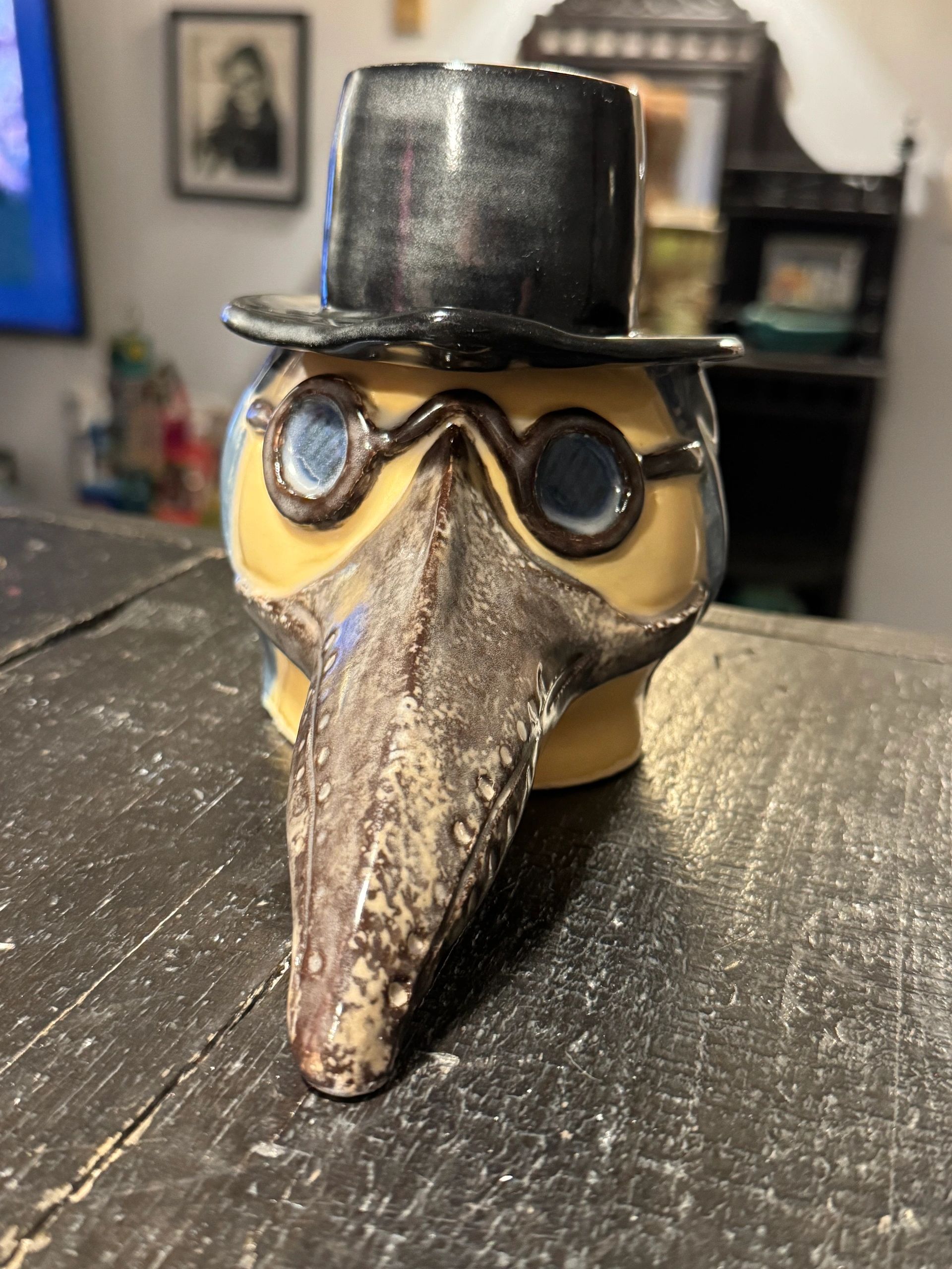 Ceramic plague doctor with top hat and glasses.