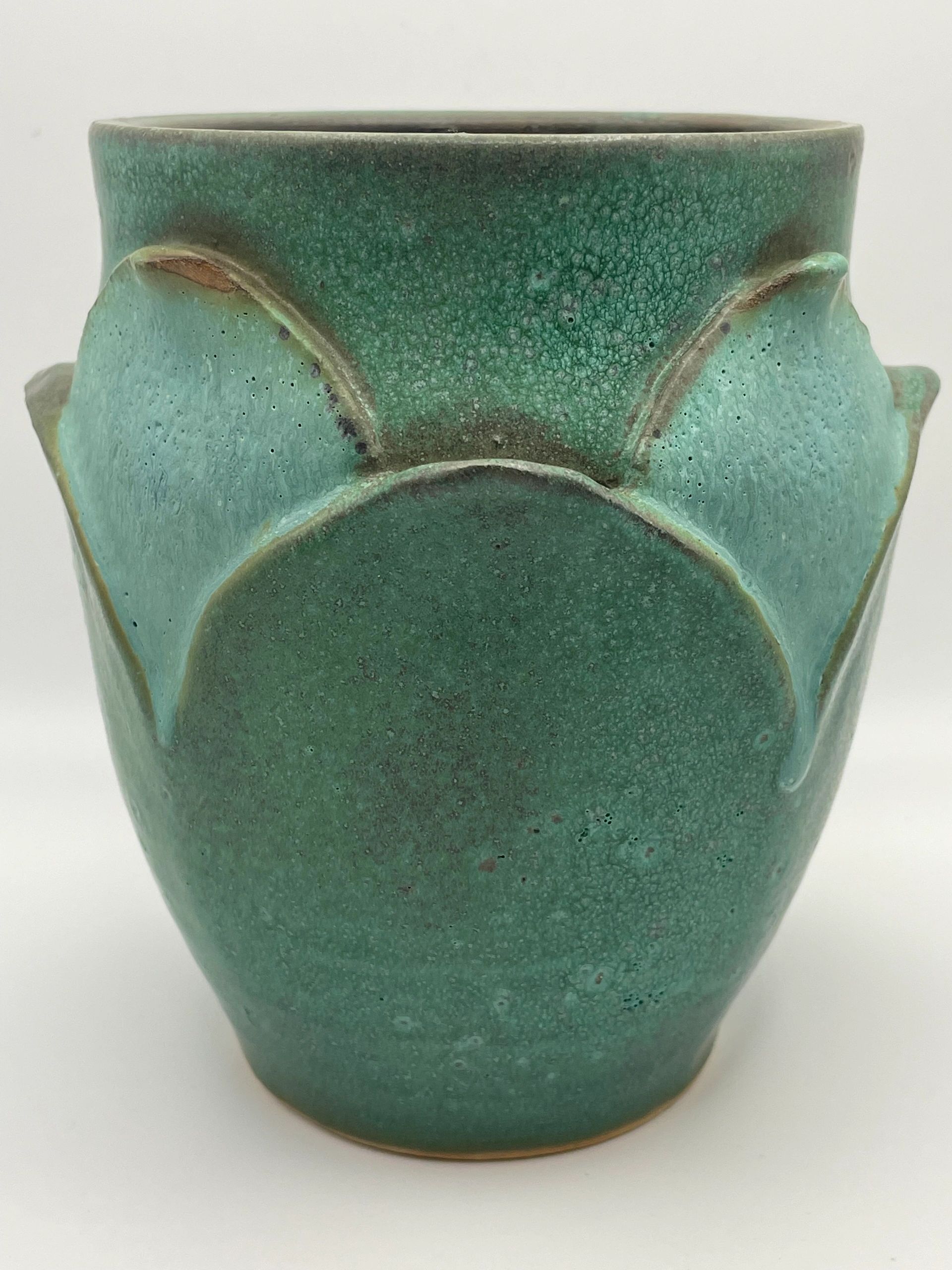 Green textured ceramic vase with a petal pattern.