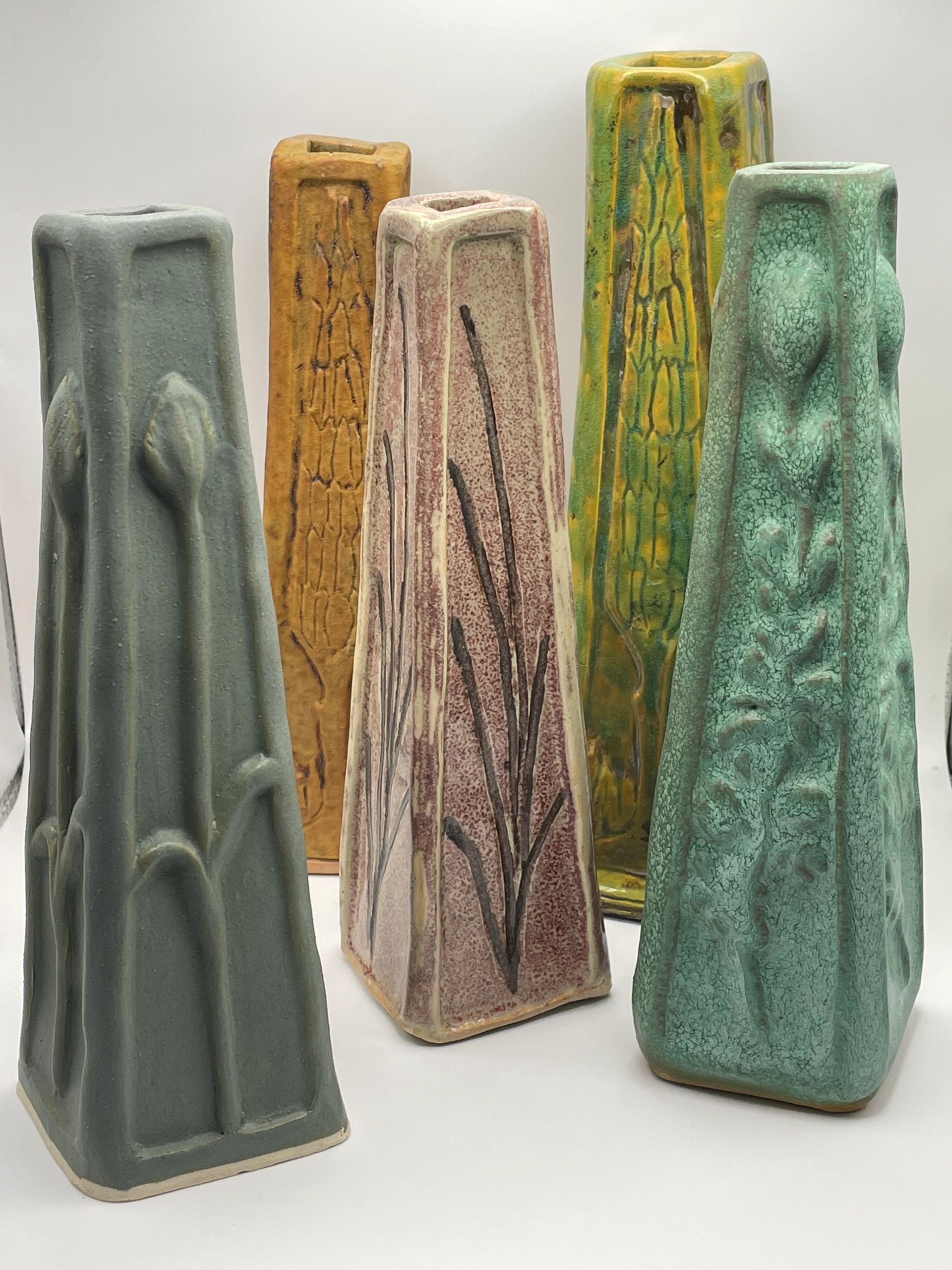 Colorful ceramic vases with textured designs.