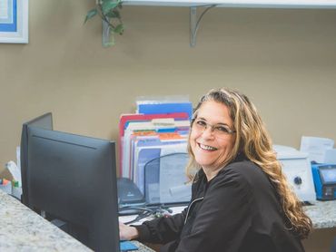 Receptionist at OWA ready to help welcome new walk in patients for sick visits.