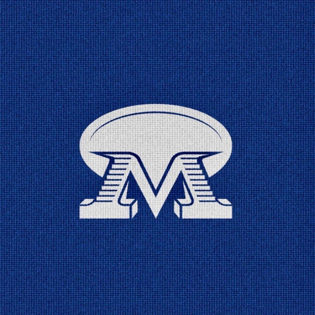 White stylized letter M with an oval shape above on a blue textured background.