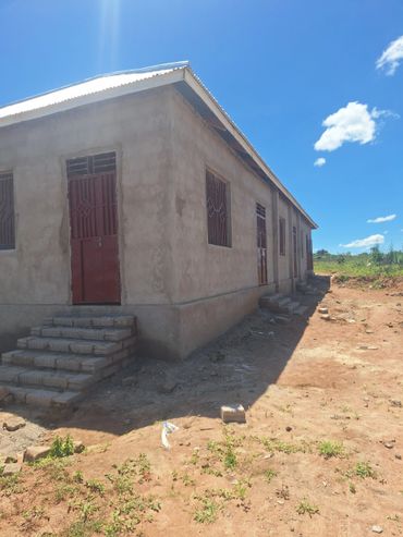 Simple concrete building under a clear blue sky.
