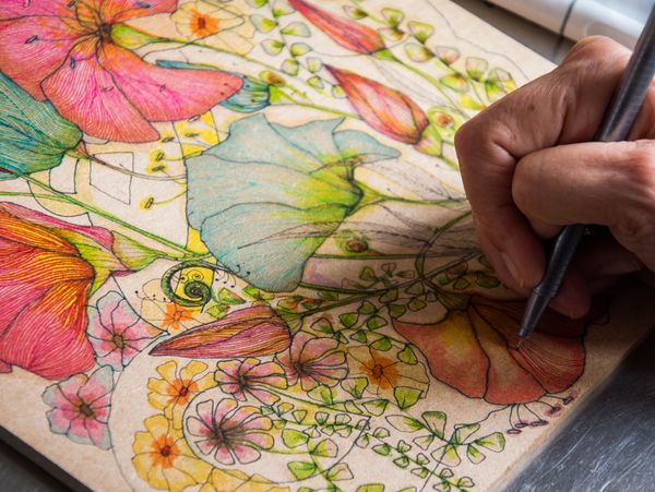 Adriana completing her flower design before using on her beautiful tote bags