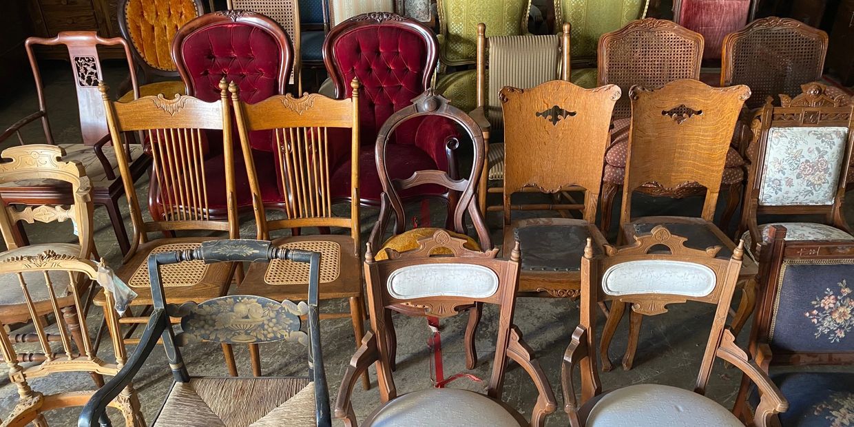 Vintage and  antique chairs displayed at a Mercanti estate sale in Vallejo, California 