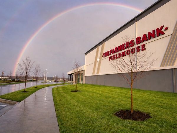 A rainbow arches over The Farmers Bank Fieldhouse on a wet day.