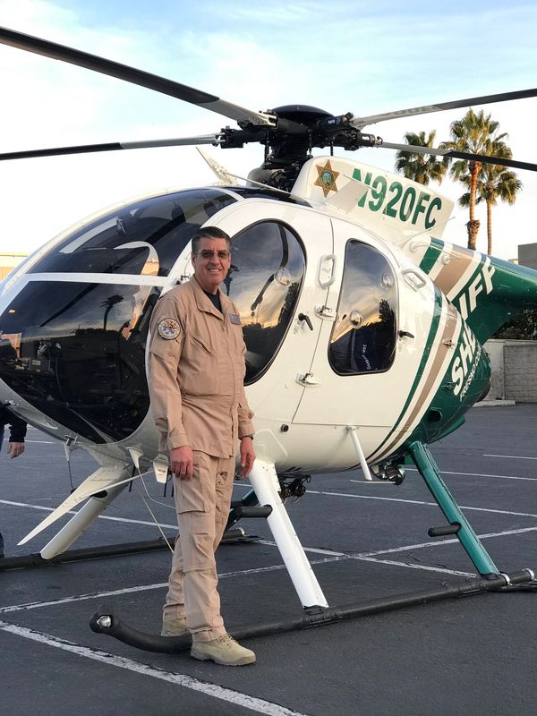 Dave next to helicopter representing law enforcement and emergency service aviation capabilities