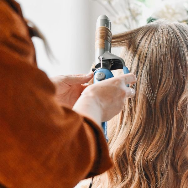 Bridal hairstylist curling hair