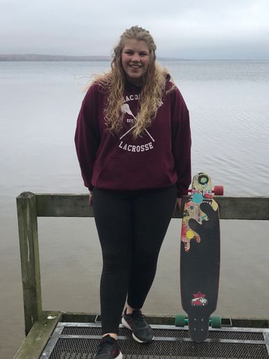 Autumn with her longboard at a Minnesota State Park.