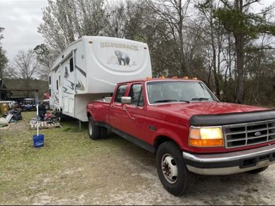 2005 Cedar Creek being towed by a 1995 F350 Dually truck.