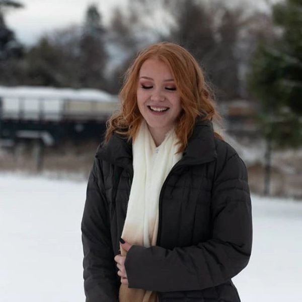 Smiling woman in winter coat outdoors.