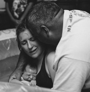 Woman after labor holding baby. Well Adjusted Birth