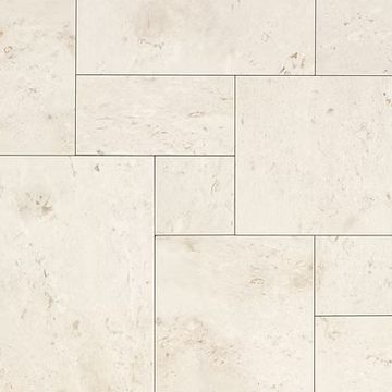 Light beige stone tiles arranged in a staggered pattern.
