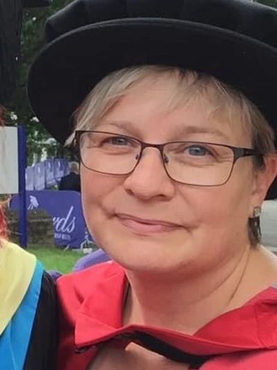 A cropped, head and shoulders image of Jackie in her PhD robes, attending student graduation ceremon
